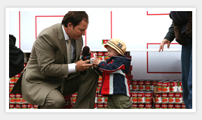 man and little girl donating cans of soup